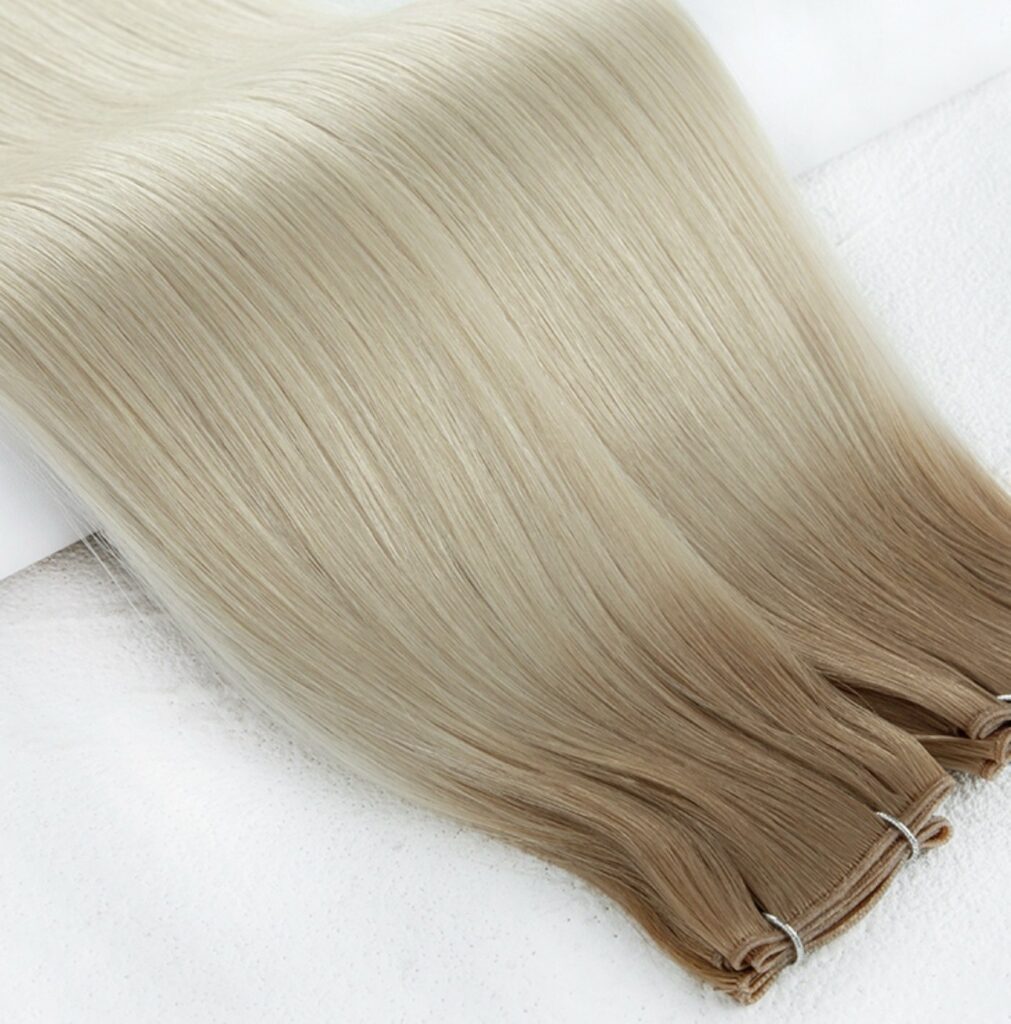 Long, straight hair extensions in a blonde-to-light brown gradient. Showcases texture and shine, ideal for hair styling.
