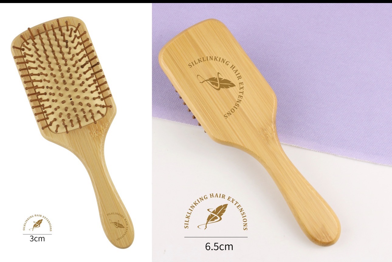 Bamboo hairbrush with a wooden handle and cushioned base, featuring the "Silklinking Hair Extensions" logo, ideal for styling and detangling hair.